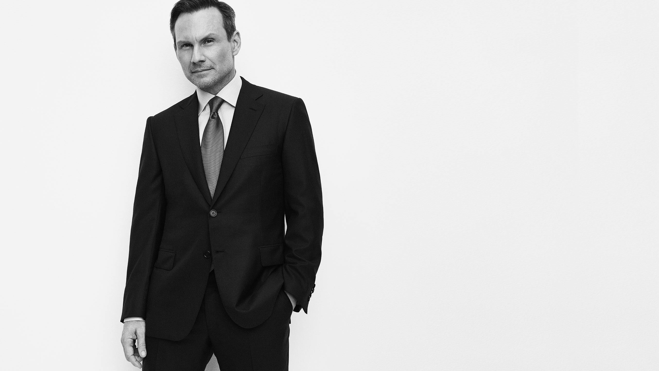 Christian Slater wearing a suit and shirt from the Brioni Essential collection