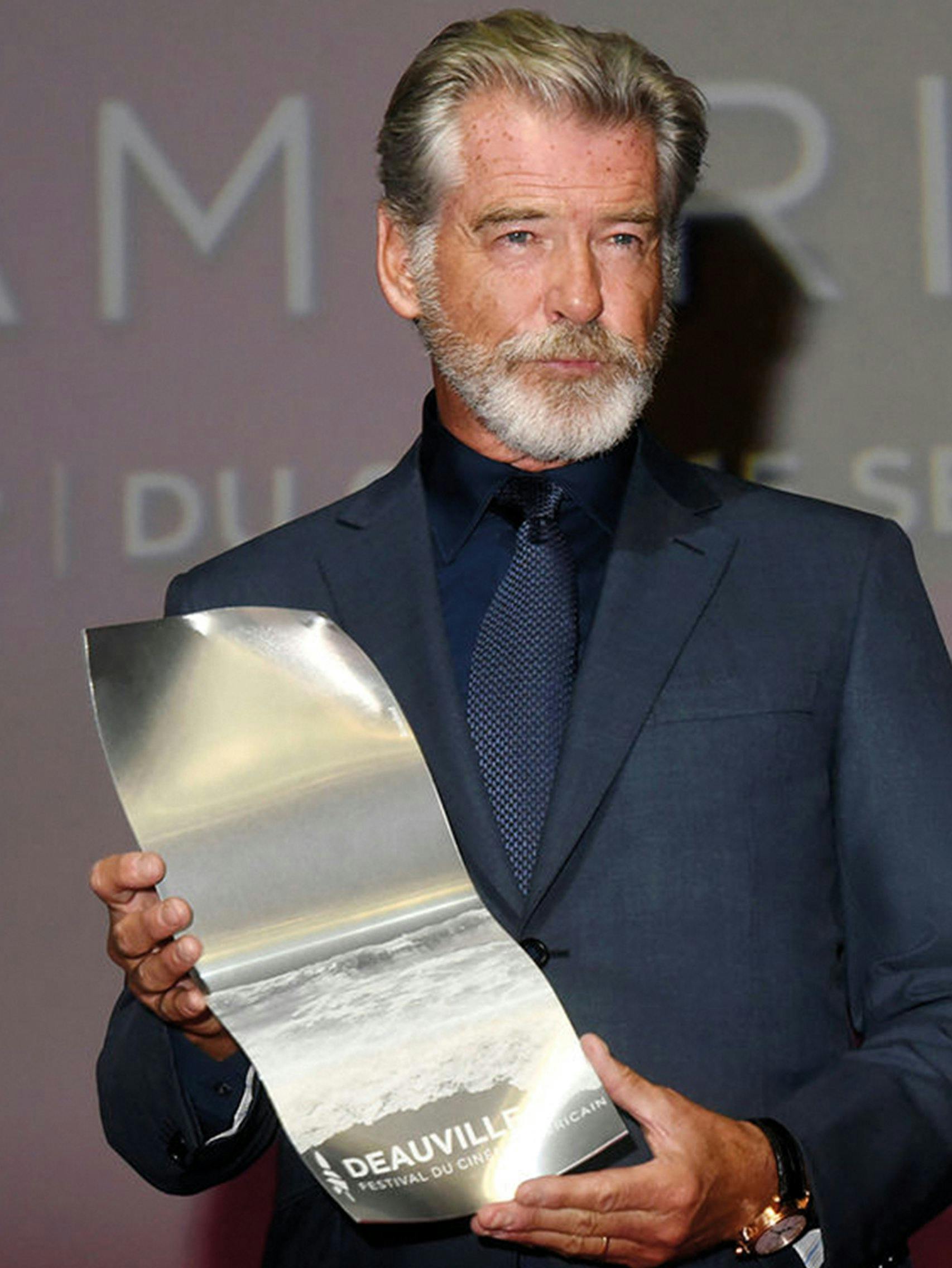 Pierce Brosnan wearing a Brioni bespoke blue suit