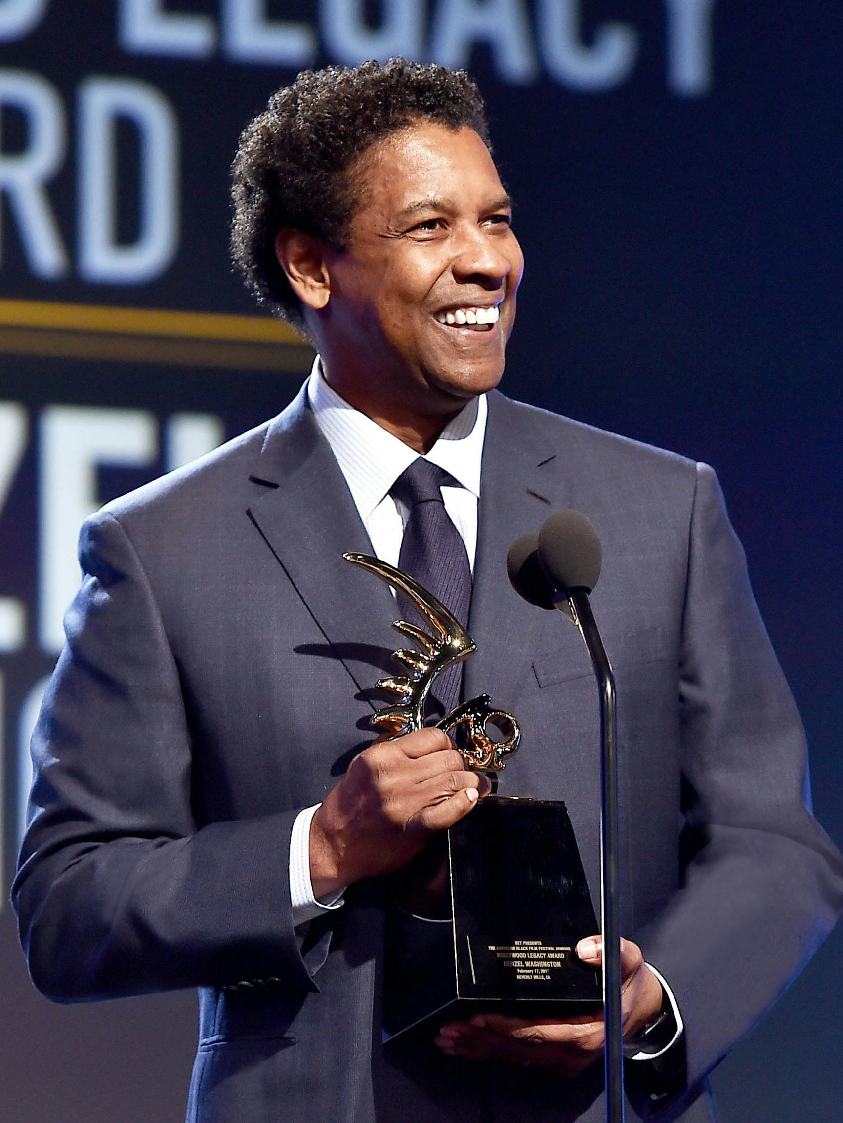 Denzel Washington wearing a Brioni bespoke blue suit