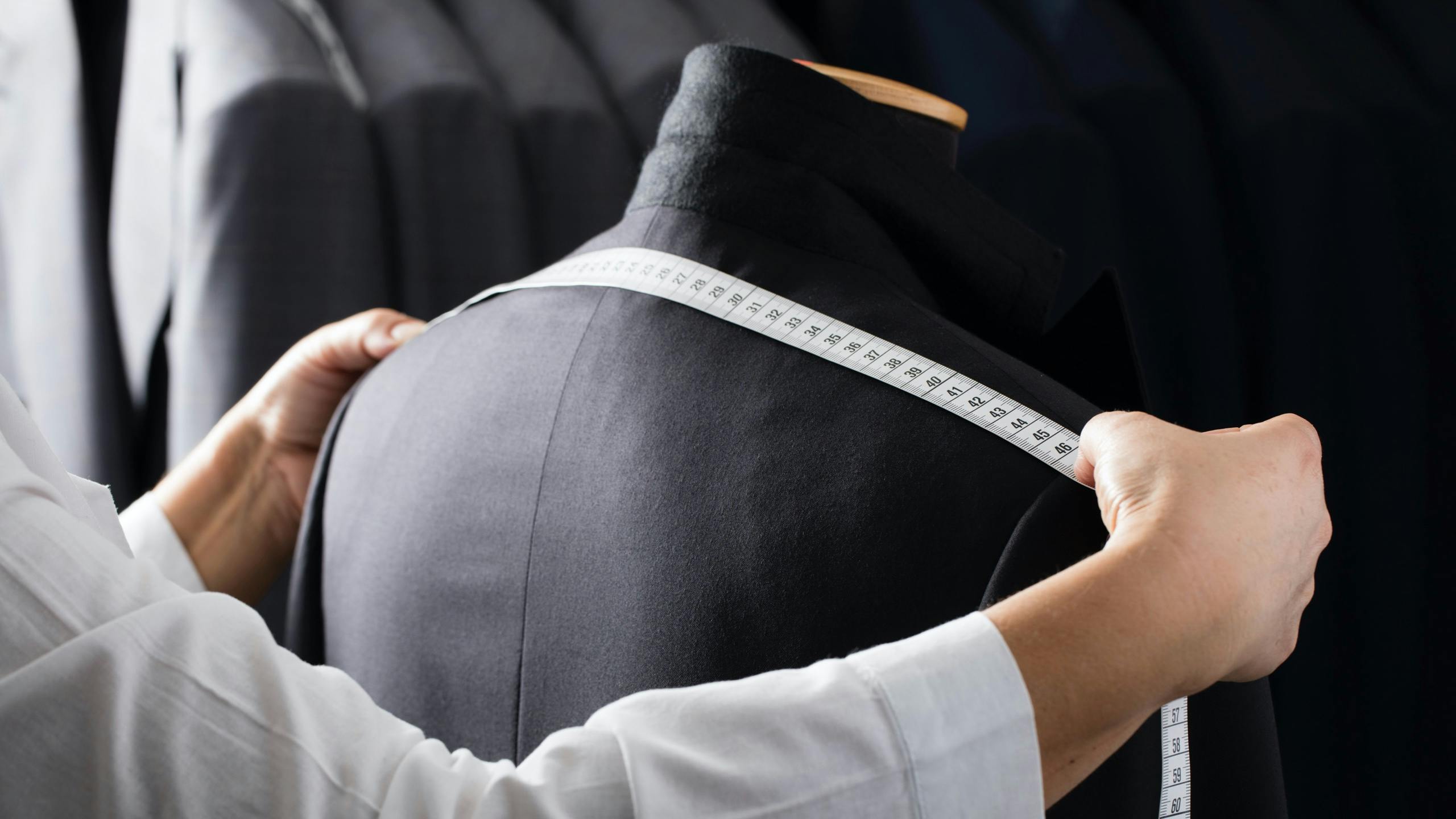 A Brioni artisan checking a jacket's measurements