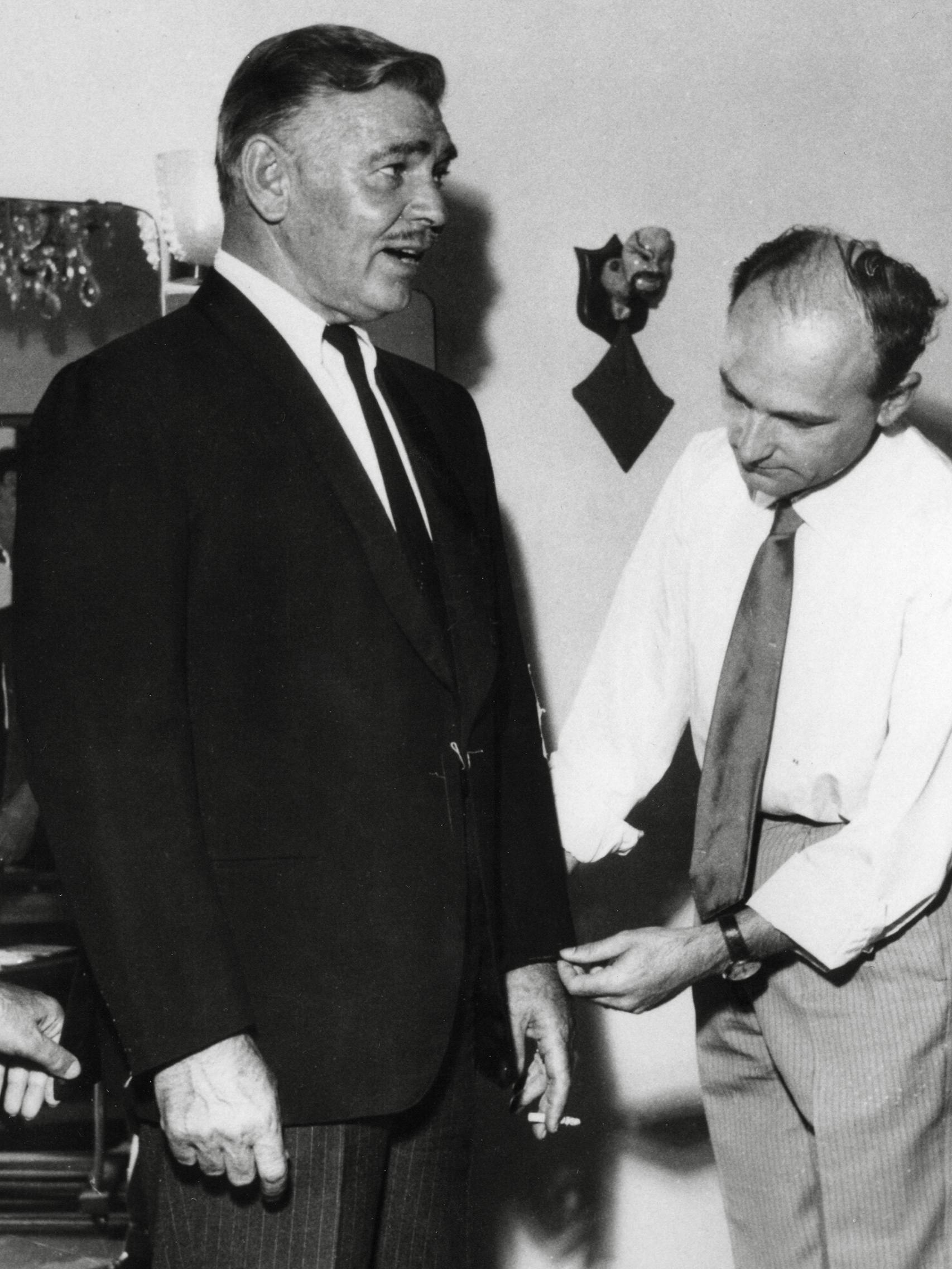 Actor Clark Gable is fitted for a Brioni suit