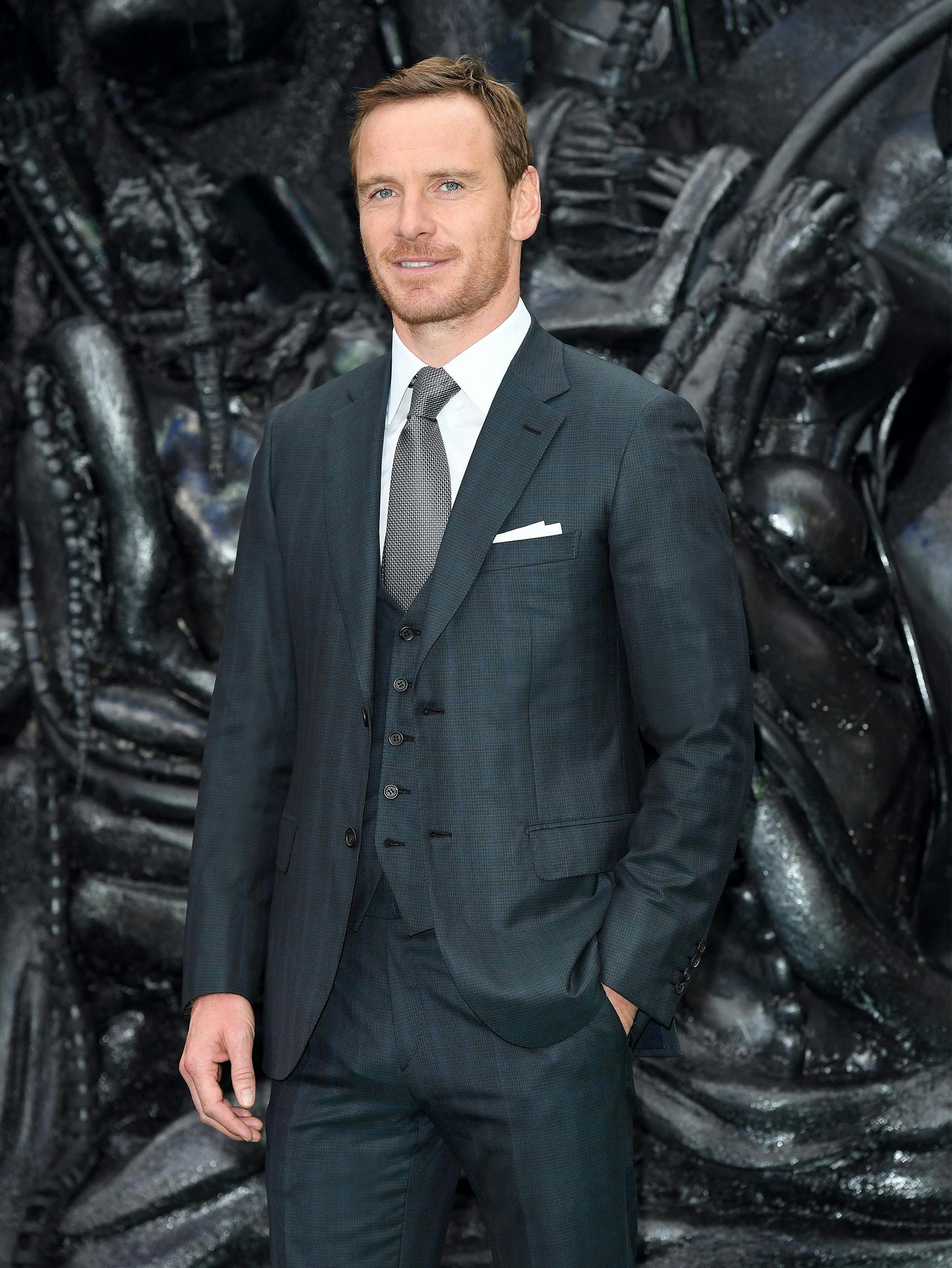 Michael Fassbender wearing a Brioni bespoke dark green three-piece suit