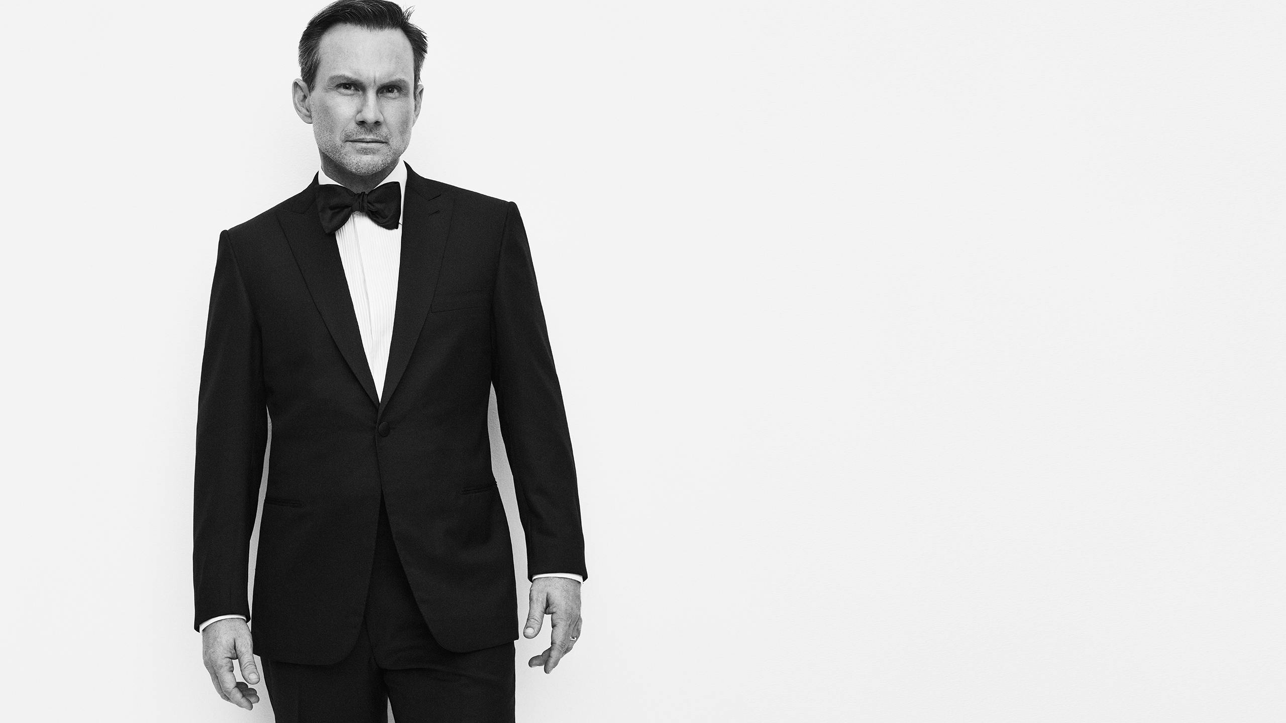 Christian Slater wearing a tuxedo, evening shirt and bow tie from the Brioni Essential collection