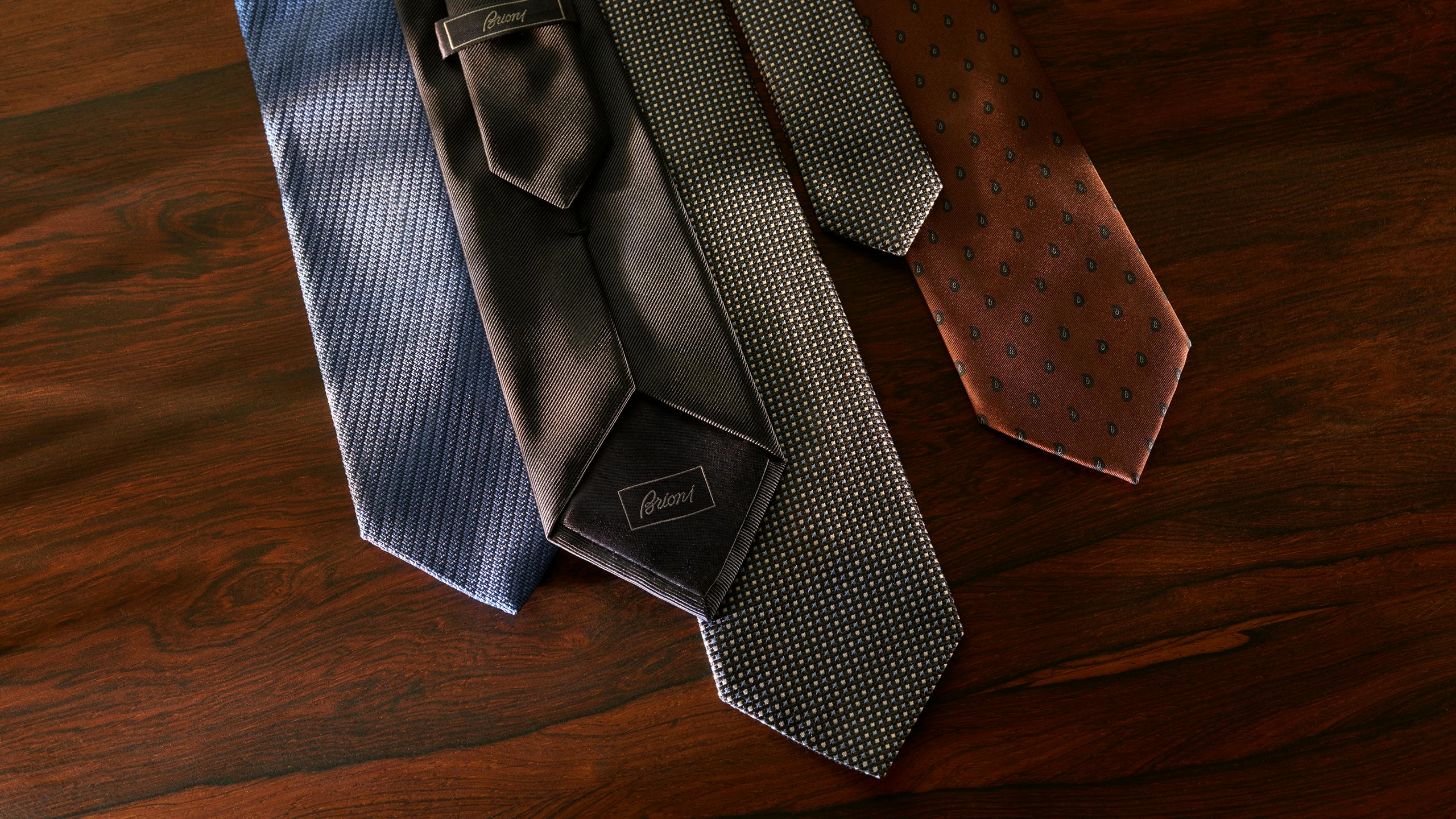 Four Brioni made-to-order ties in different fabrics and patterns